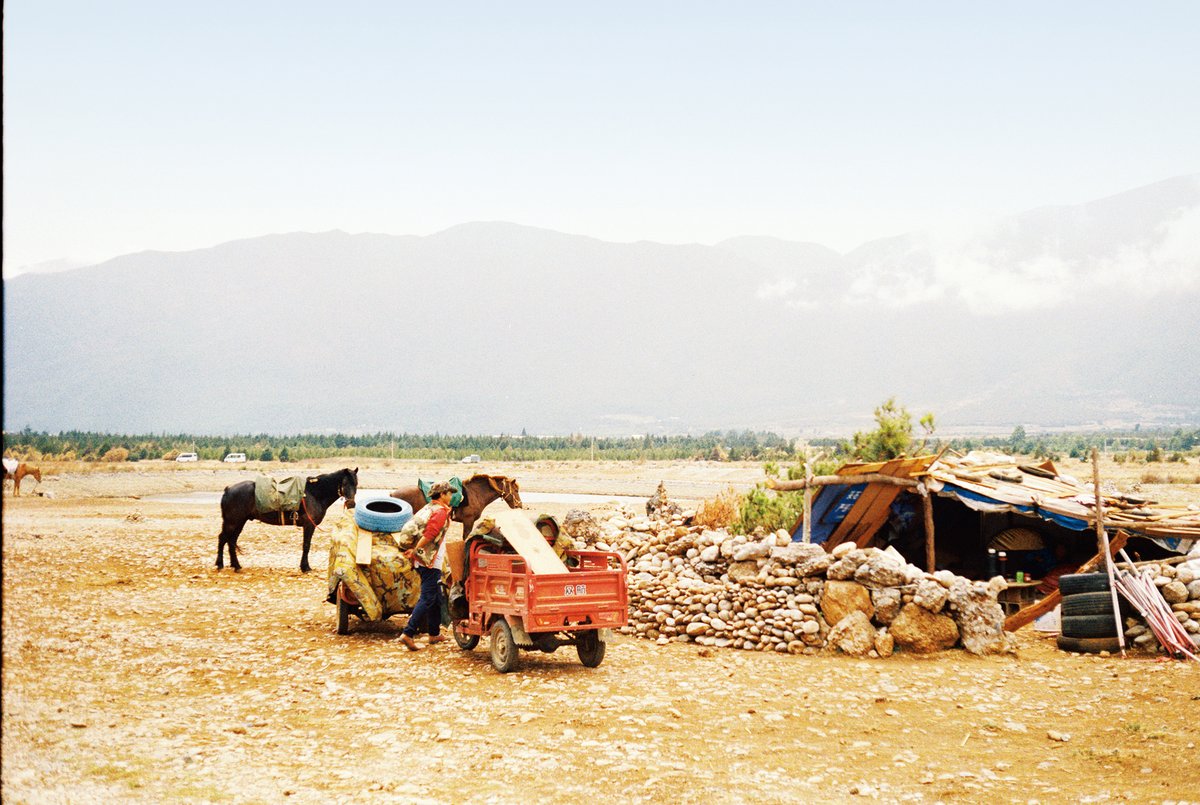 Nomads on horseback encamped in the foothills of Jade Dragon Snow Mountain northwest of Lijiang