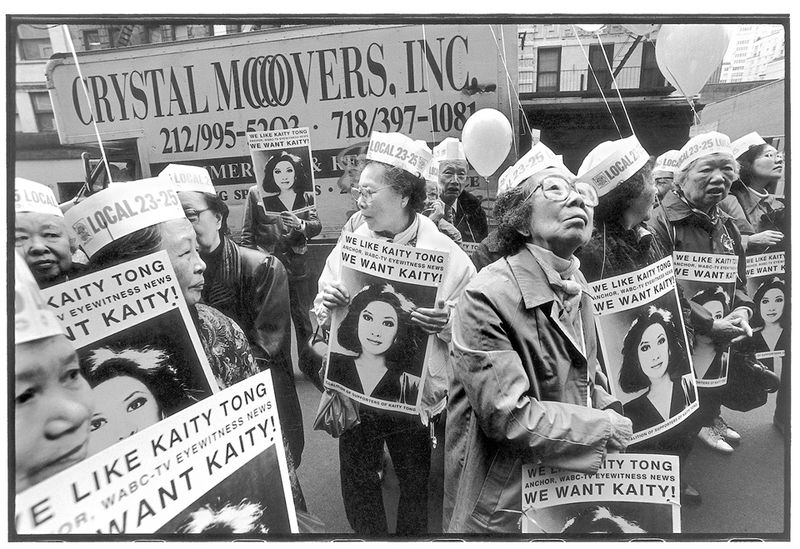 Garment union members of ILGWU Local 23-25 rally against the firing of Kaity Tong, the first Chinese American TV news anchor. NYC, 1991.