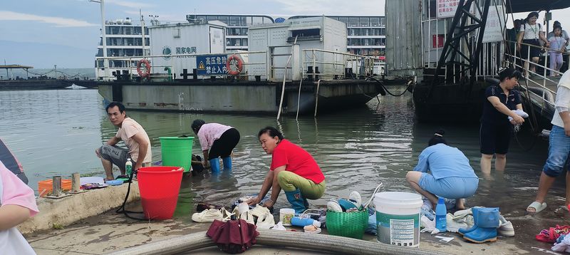 locals washing next to Shibaozhai Wharf