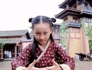 A boy with the zongjiao hairstyle which consists on two braided knots on each side. 