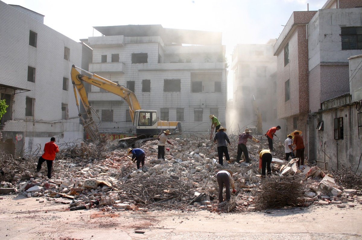 At the demolition site, scavengers look for abandoned steel bars to sell to junk yards