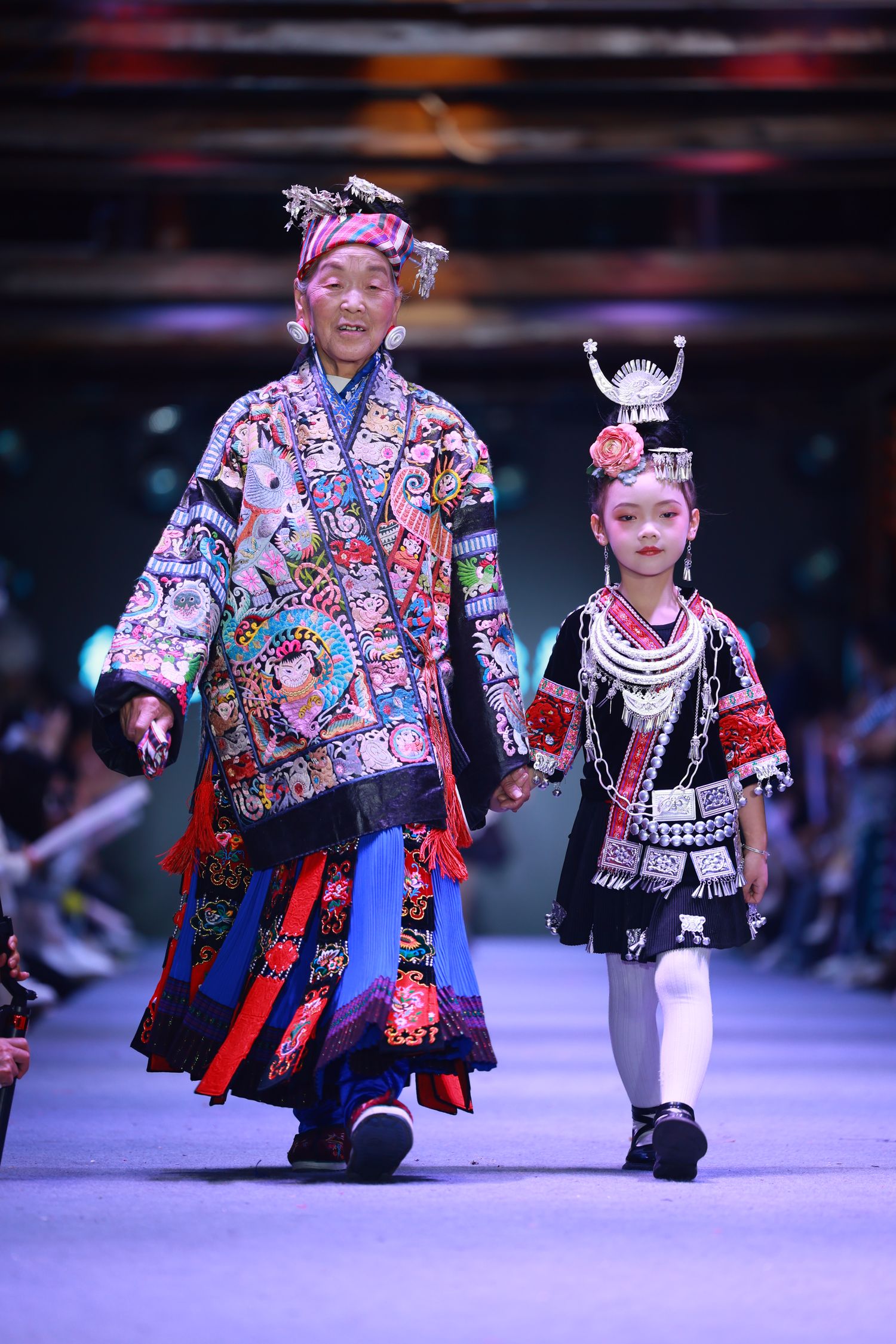 Participants of the show range from young children to elders in their 80s. Pan Yuzhen (left), a 80-year-old local embroiderer, is one regular model