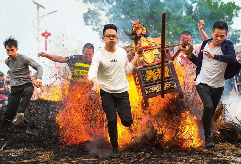 “Tests of Faith”: Villagers in parts of southern China carry their gods through a series of bonfires as a Lantern Festival tradition (Puning Guangdong, Province, March 2018)