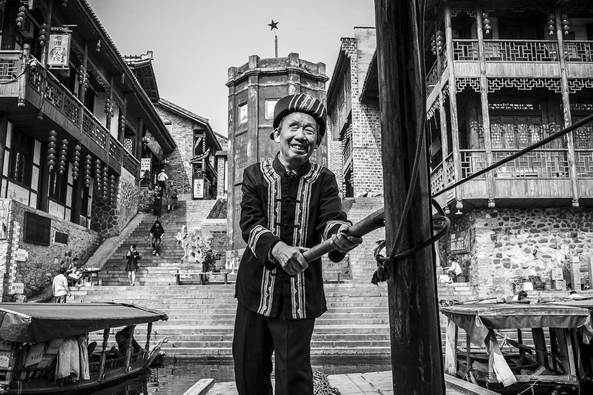 traditional boatman in fenghuang ancient town