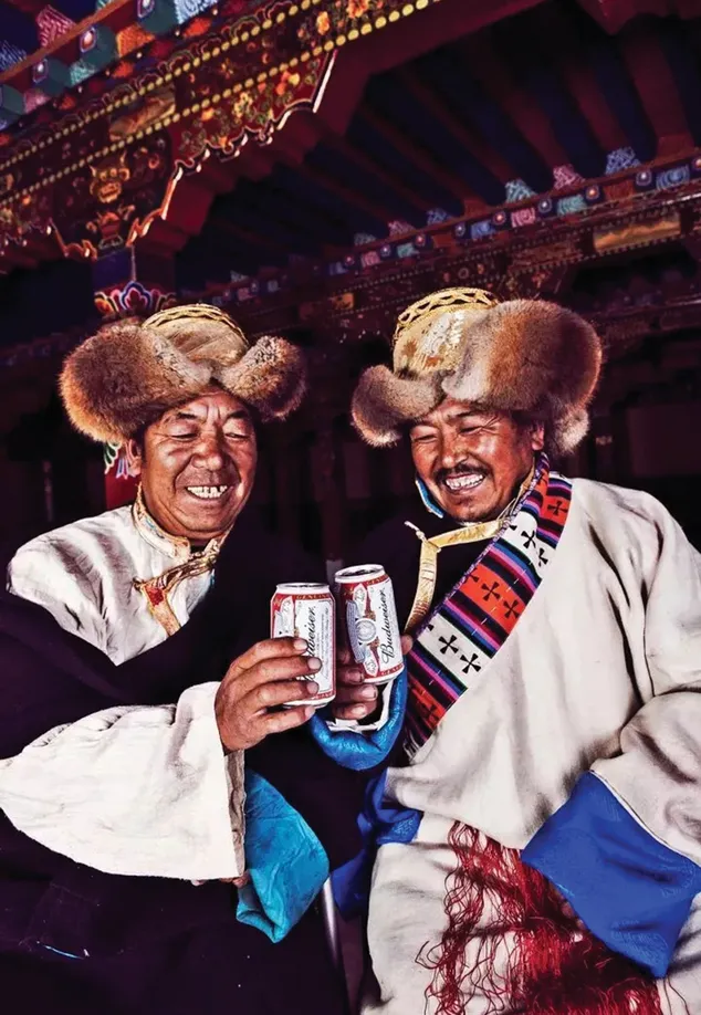 Nyema Droma’s uncle enjoys a beer with a friend in her 2014 series “Modernizing the World Roof”