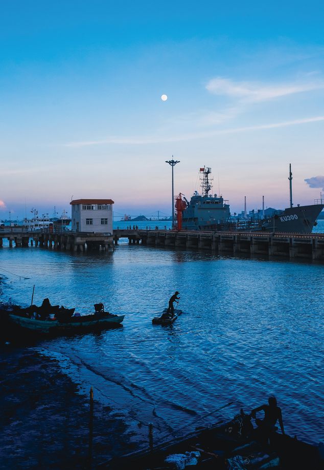 Fishermen return to the harbor at dusk