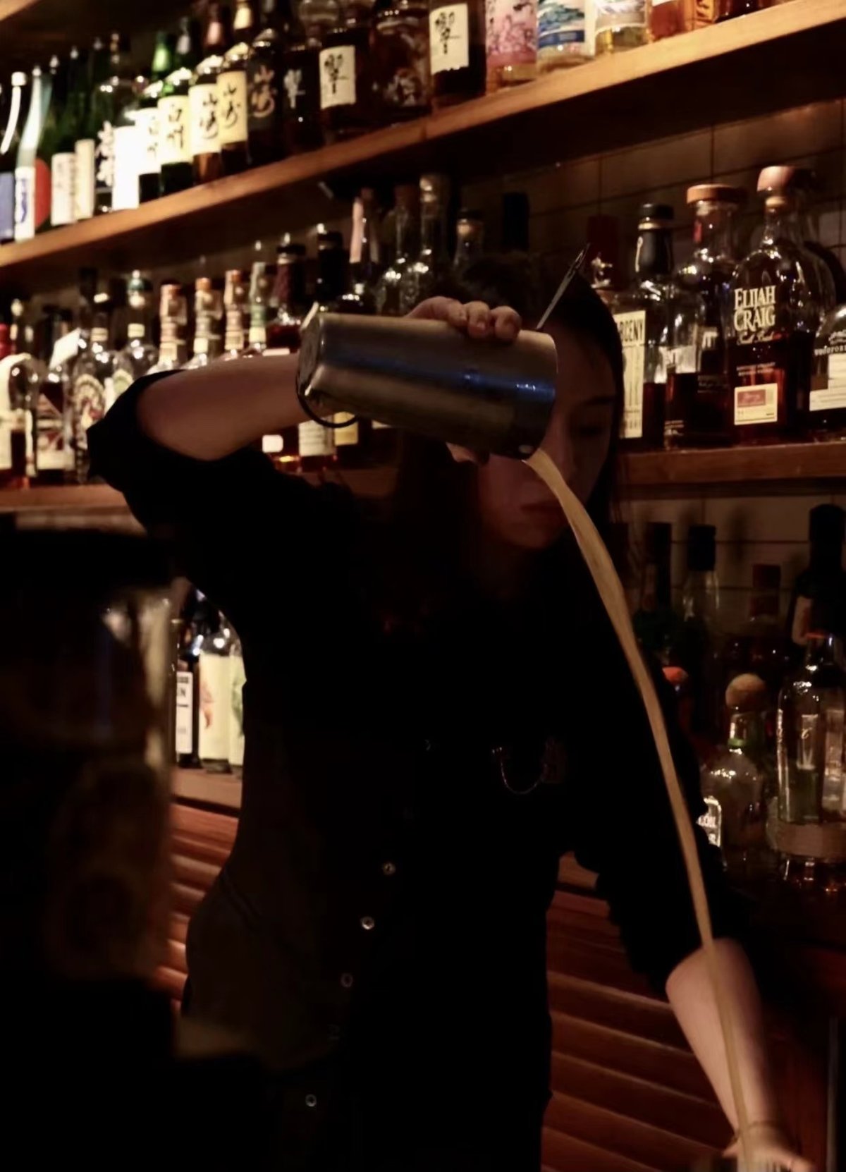 Xu mixing drinks at her bar in Hangzhou