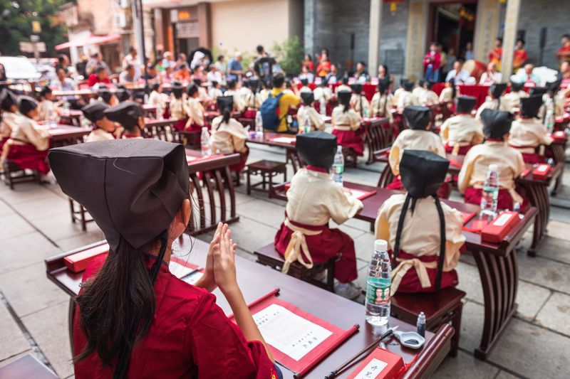 Students in hanfu wait patiently for the First Writing Ceremony to begin