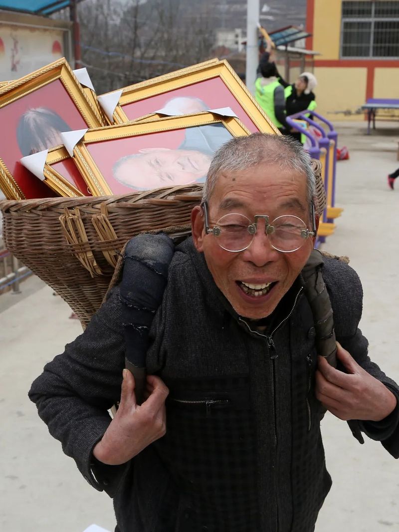 Village secretary transporting portraits home to Chinese elders