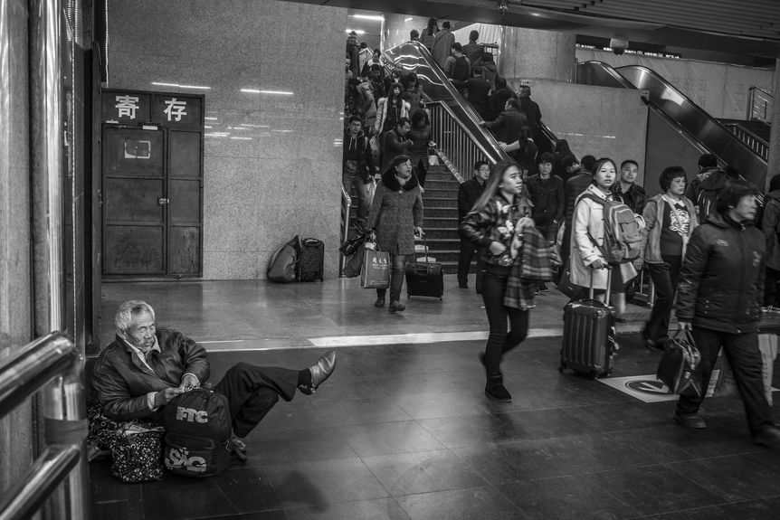 man sleeping in Beijing train station