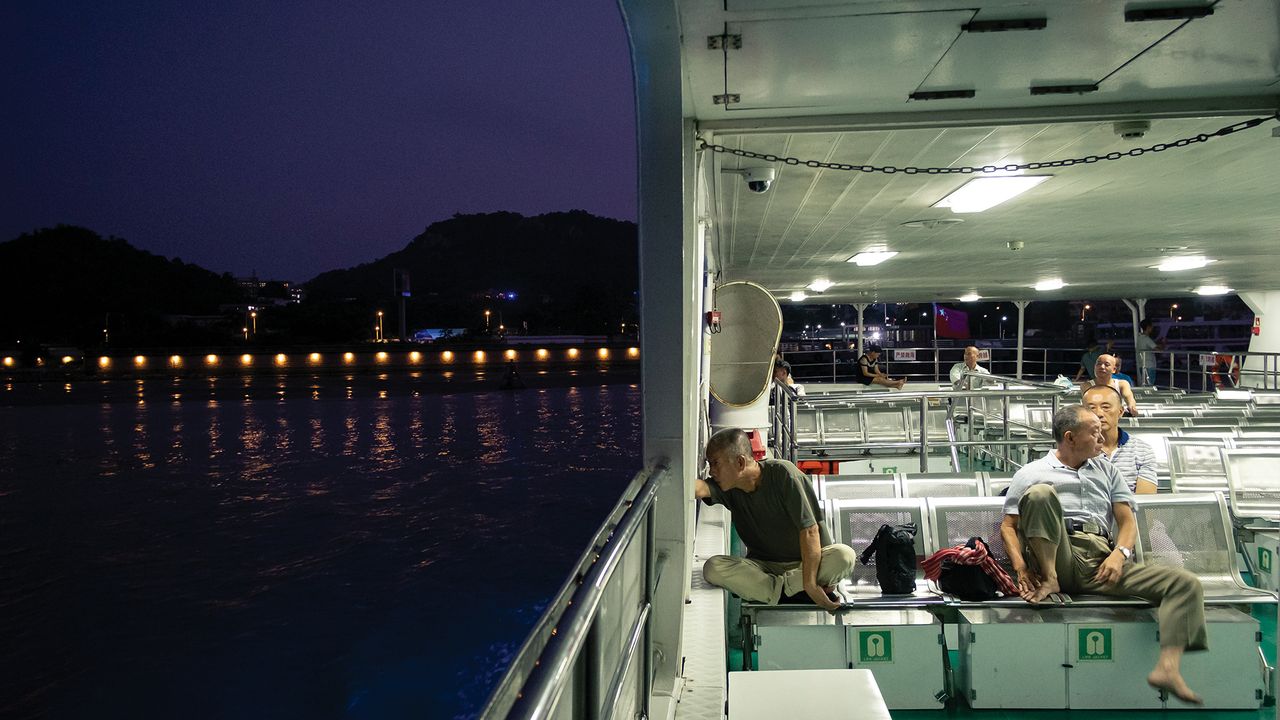 Passengers are few on the last ferry of the day between downtown Shantou and the suburban Haojiang district