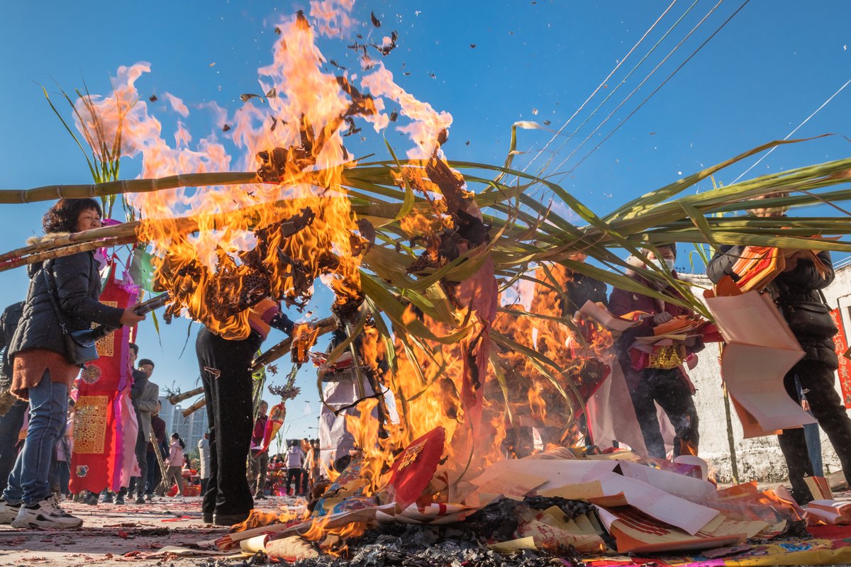 Paper money tied to the sticks is burnt, while the sugarcane remains intact