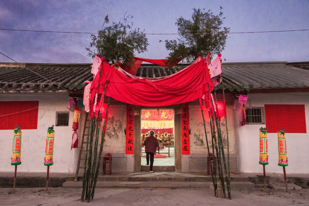 The Cai family’s ancestral hall is decorated with red couplets, banners, and lanterns for the most important event of the year