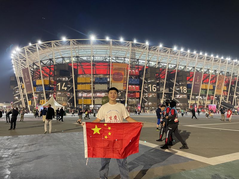A Chinese World Cup soccer fan holding a Chinese flag