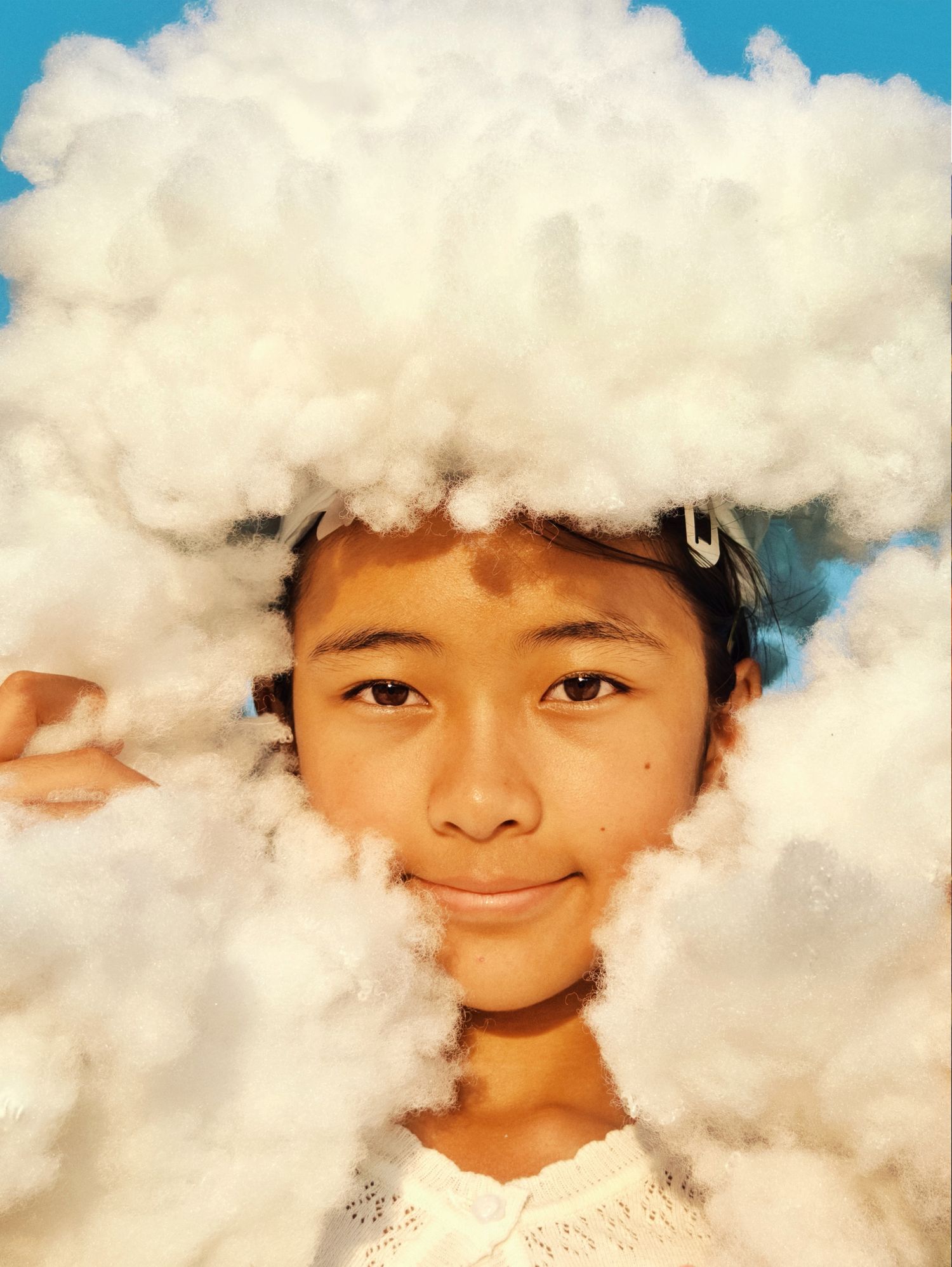 A Blang ethnic group boy holding up cotton