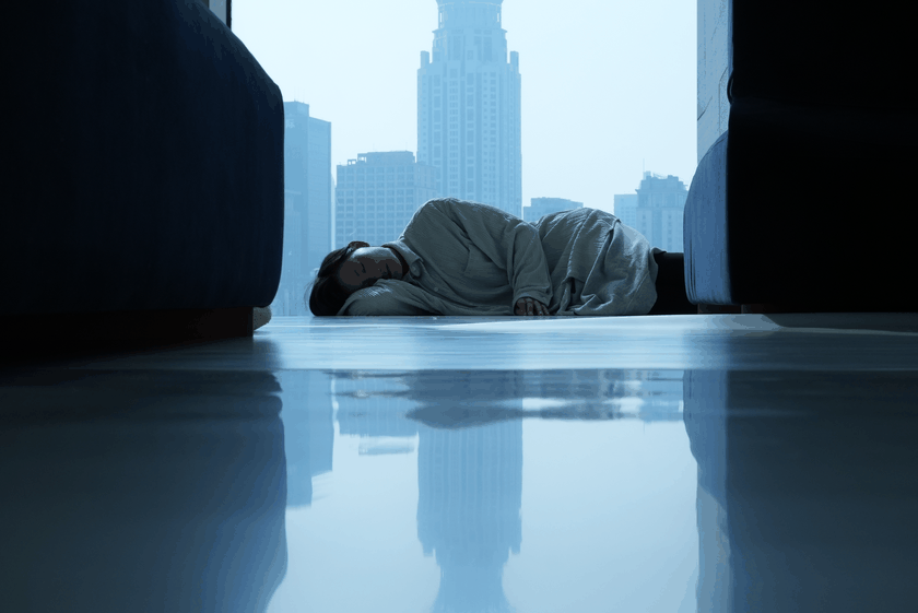 Dancer Jin Xiaoyan relaxes before a performance at the Museum of Art Pudong, with the Shanghai skyline along the Huangpu River visible outside the window