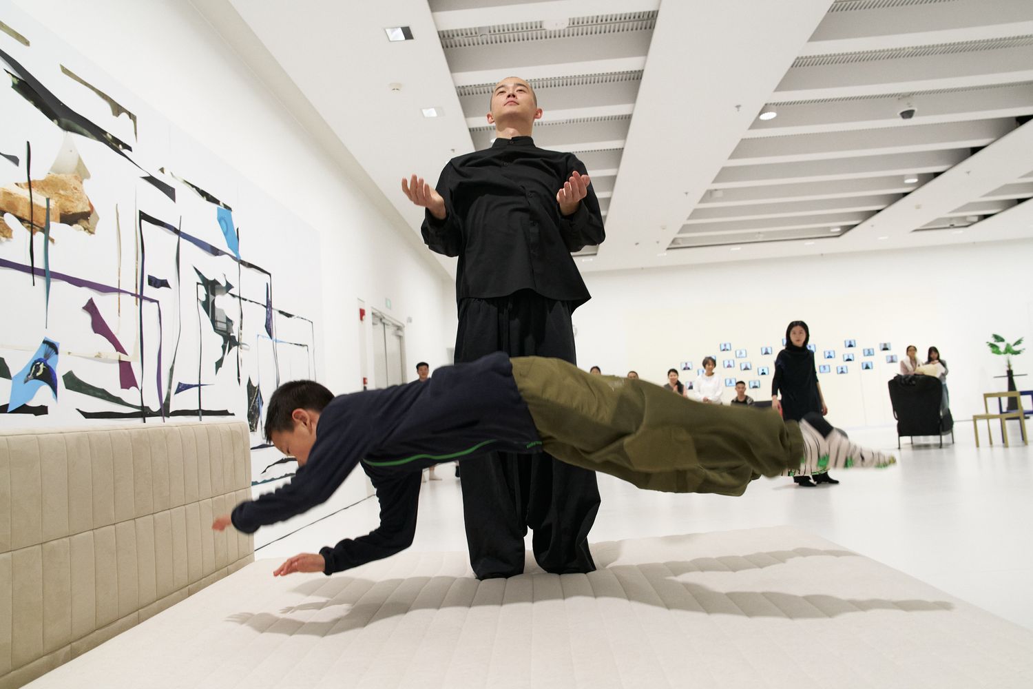 Dancer Yan Yulin interacts with an elementary school student from the audience during trampoline jumping
