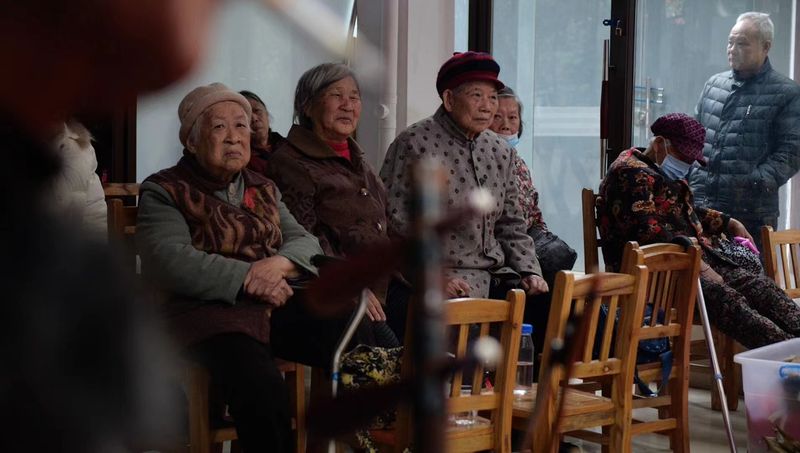 Elderly audience members watching a performance