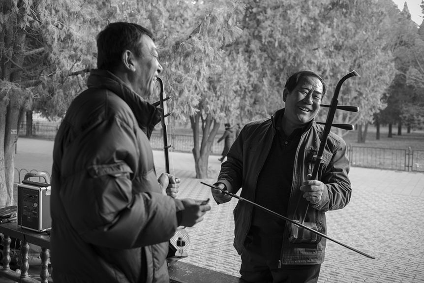 old men playing music in park in china