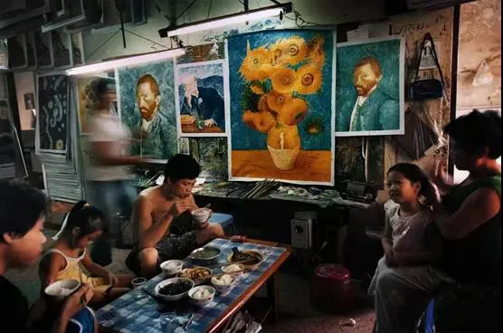 Assembly line workers eating in an art room, paintings of  Van Goghs surrounding them (China’s Van Goghs)