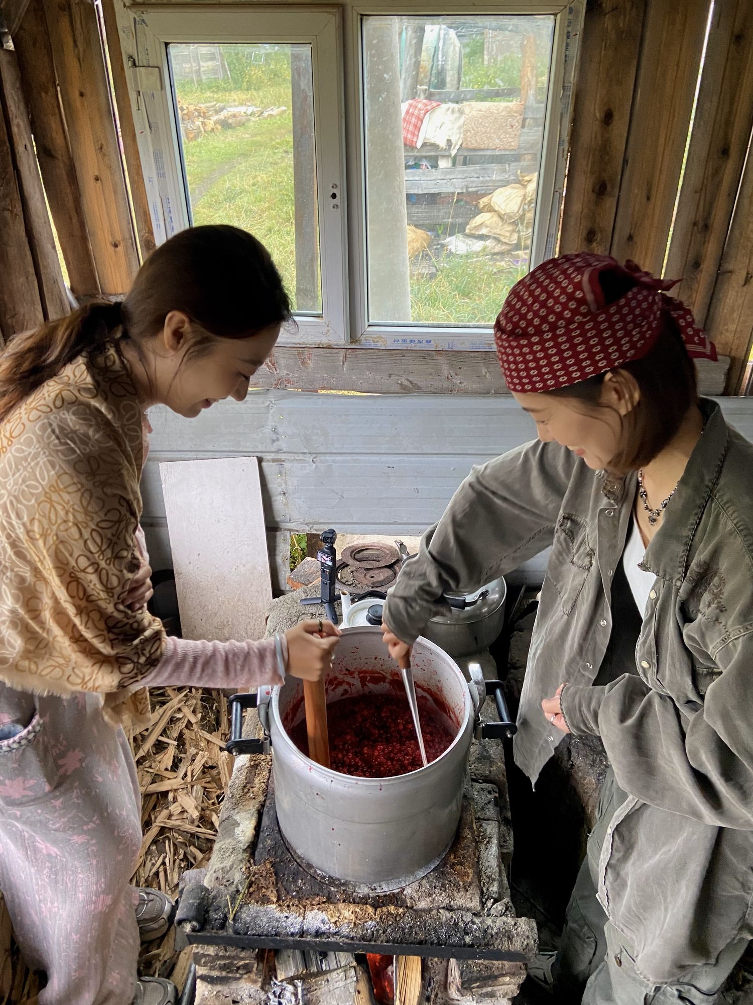 Two visitors on a short stay try their hand at making wild grape sauce in Altay