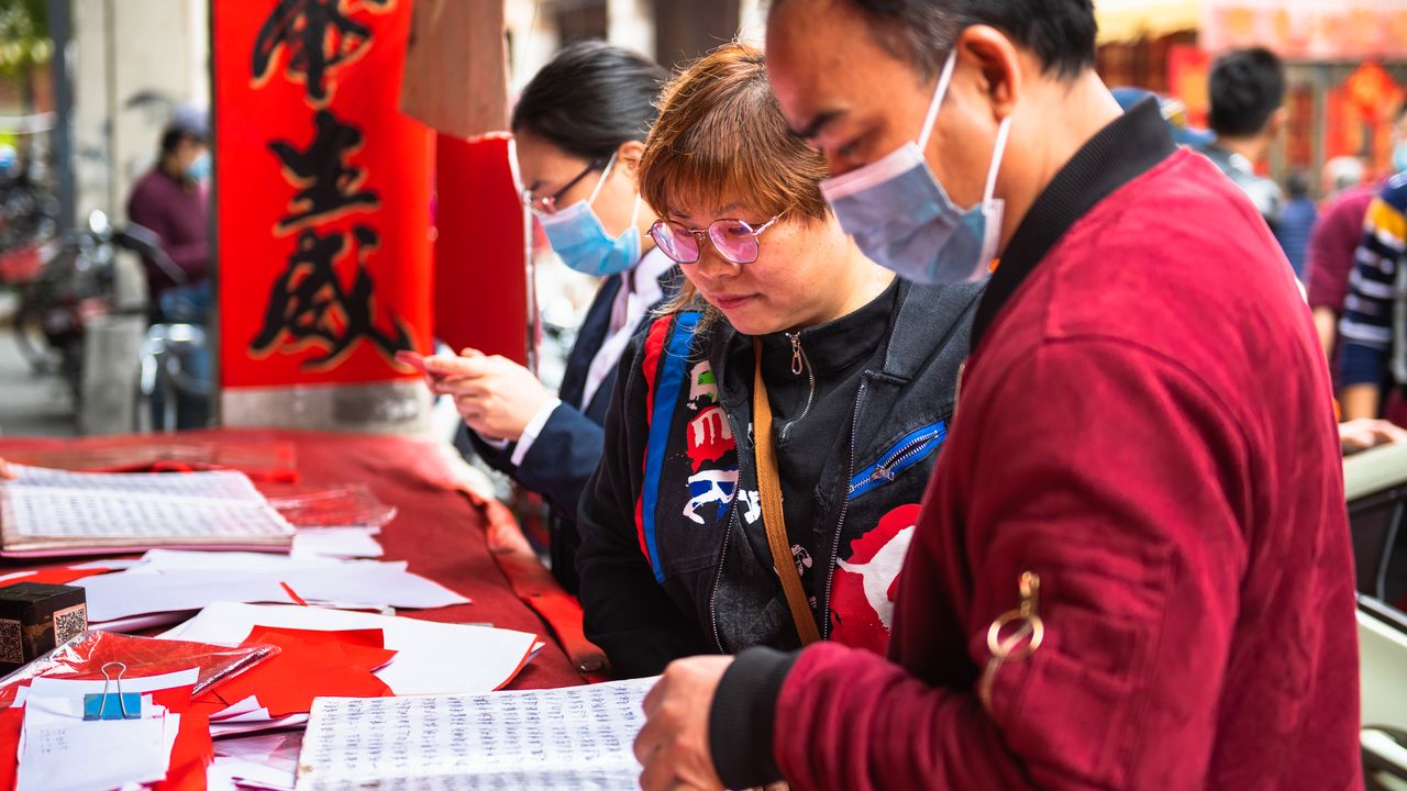 Customers at a calligrapher’s stall in China during the New Year