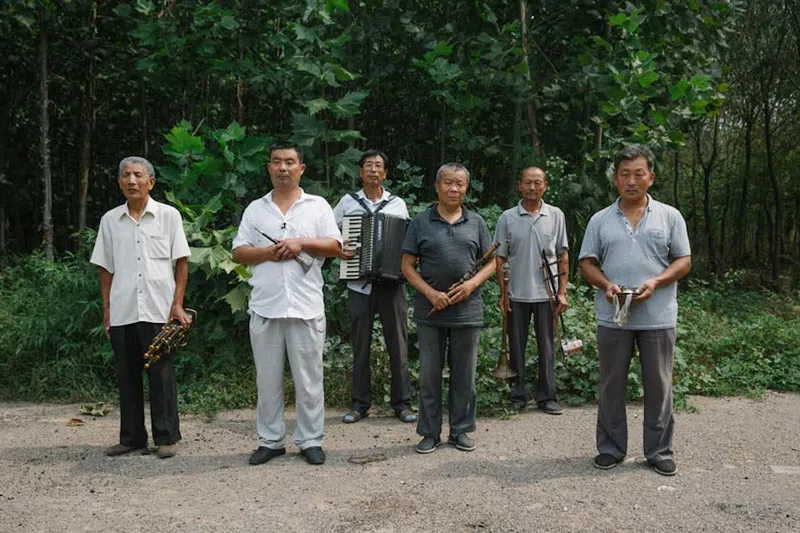 Six fellow musicians, including a couple members behind the Chinese suona
