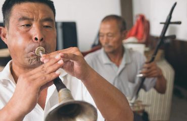 Chinese man playing the suona