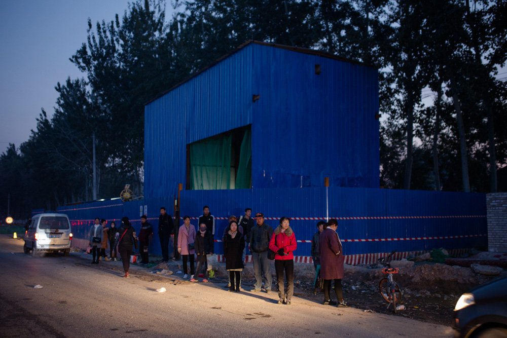 Chinese pedestrians waiting to cross the street