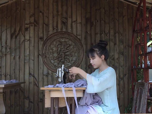 Li Ziqi working on a sewing project
