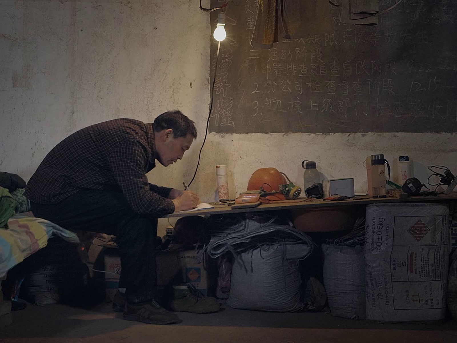 Miner reading at his desk