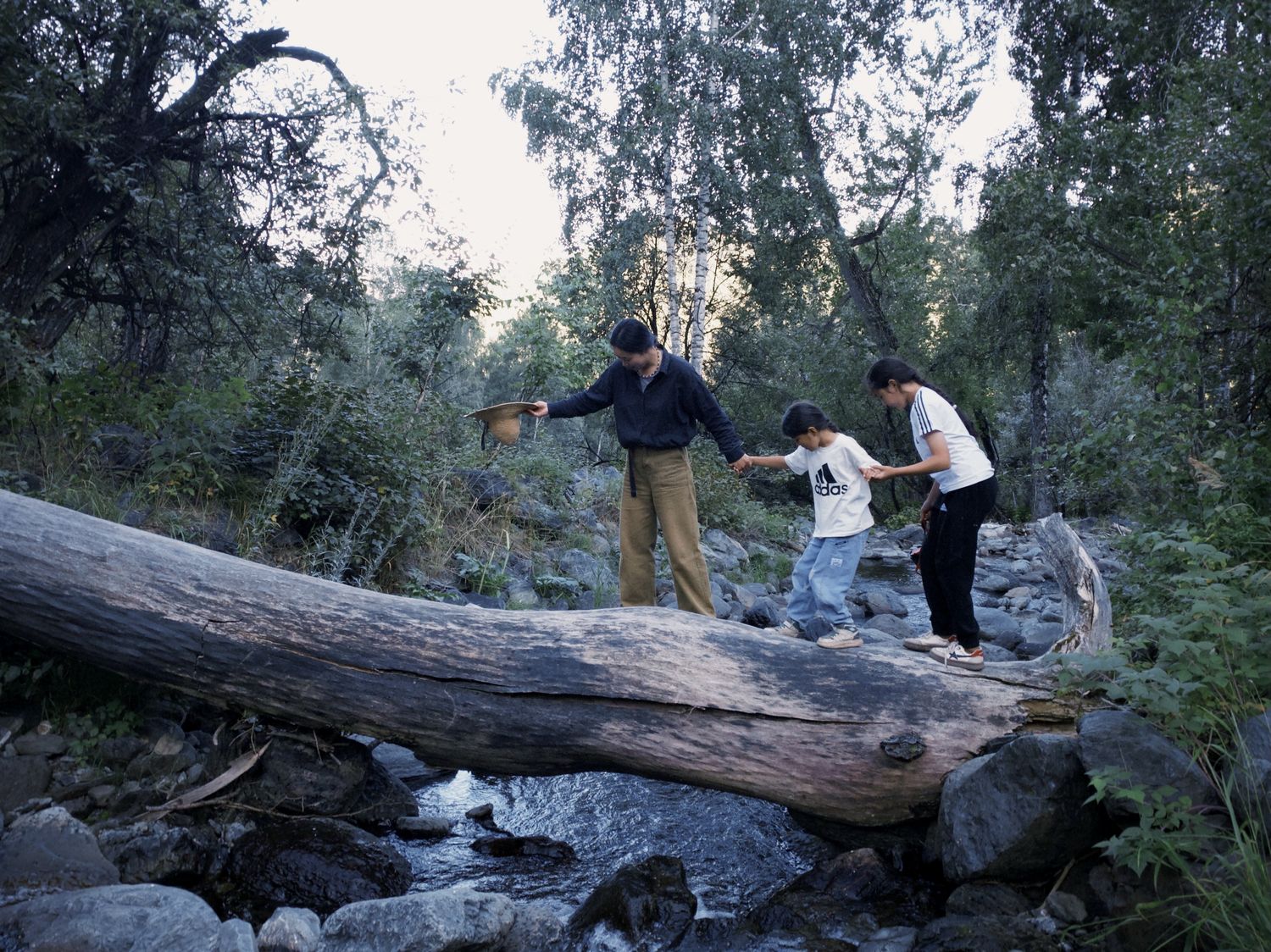 The author is leading village children on an exploration across creeks in the nearby forests