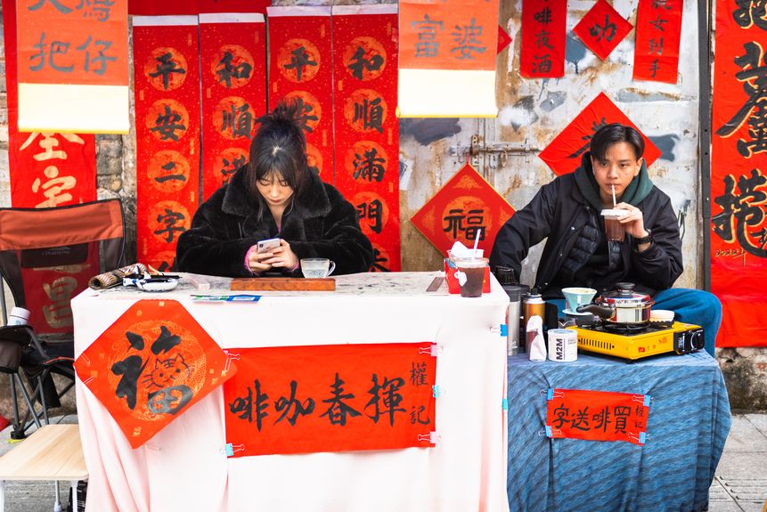 Young street vendors in China selling New Year calligraphy