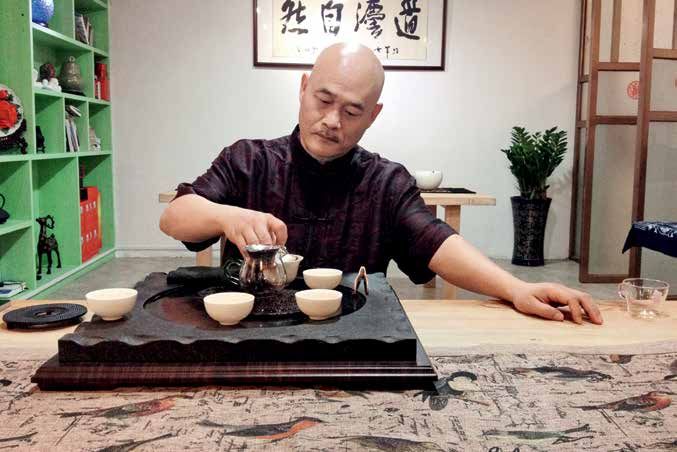 Carefully, Chai engages in the precious last stage of the tea making process: enjoying his hard labor