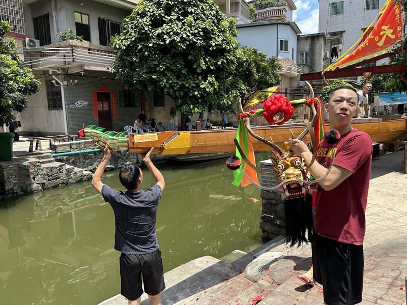 Villagers prepare their dragon boat before the competition