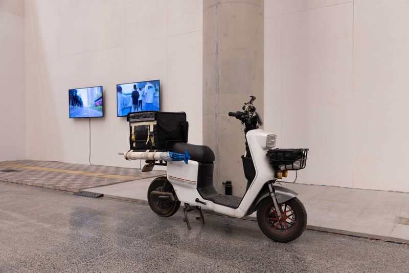 Li spent half a year delivering takeout on this scooter before placing it in his exhibition