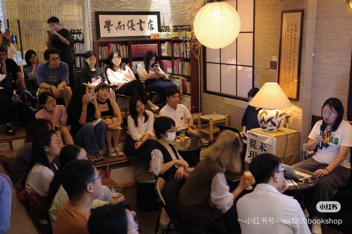 Young Chinese professionals listen in to a lecture at an academic bar