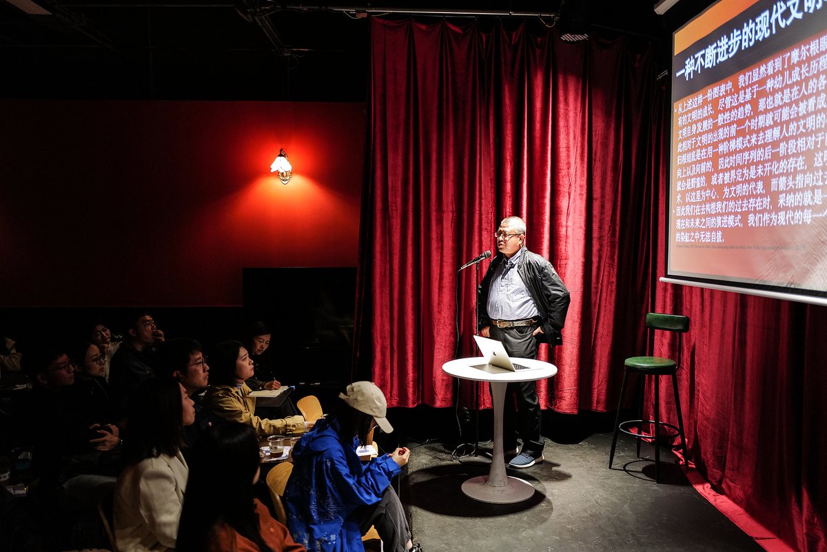 A Chinese professor giving a lecture at an academic bar in Beijing