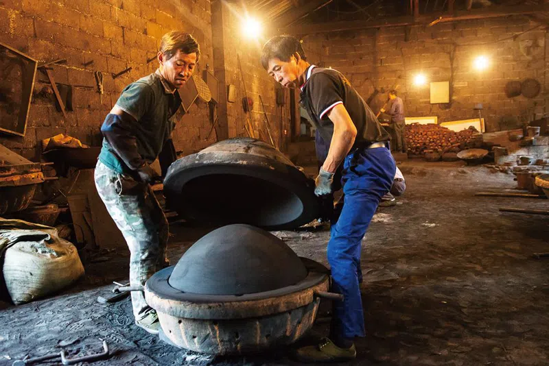 Chinese factory employees show how molding a Chinese wok comes together.