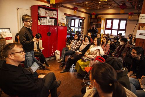 Audience members engage in discussion with speakers.