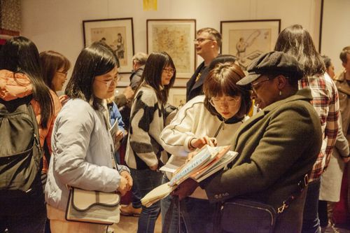 After the event audience members looking at The World of Chinese magazines.