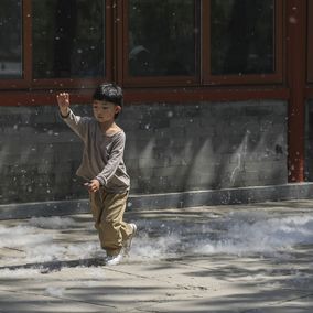 Beijing boy playing in catkin outside