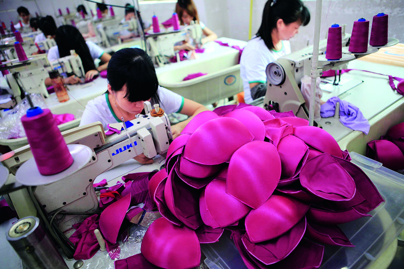 Workers create padded lingerie at a factory in Guangdong Province