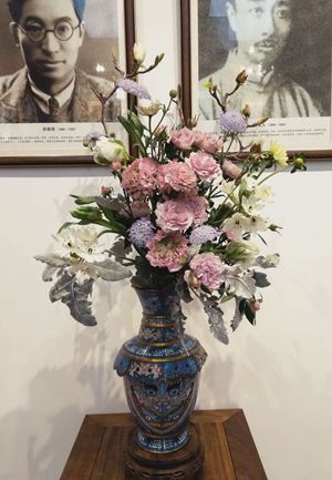 Chinese flower arrangement in blue and pink flower vase