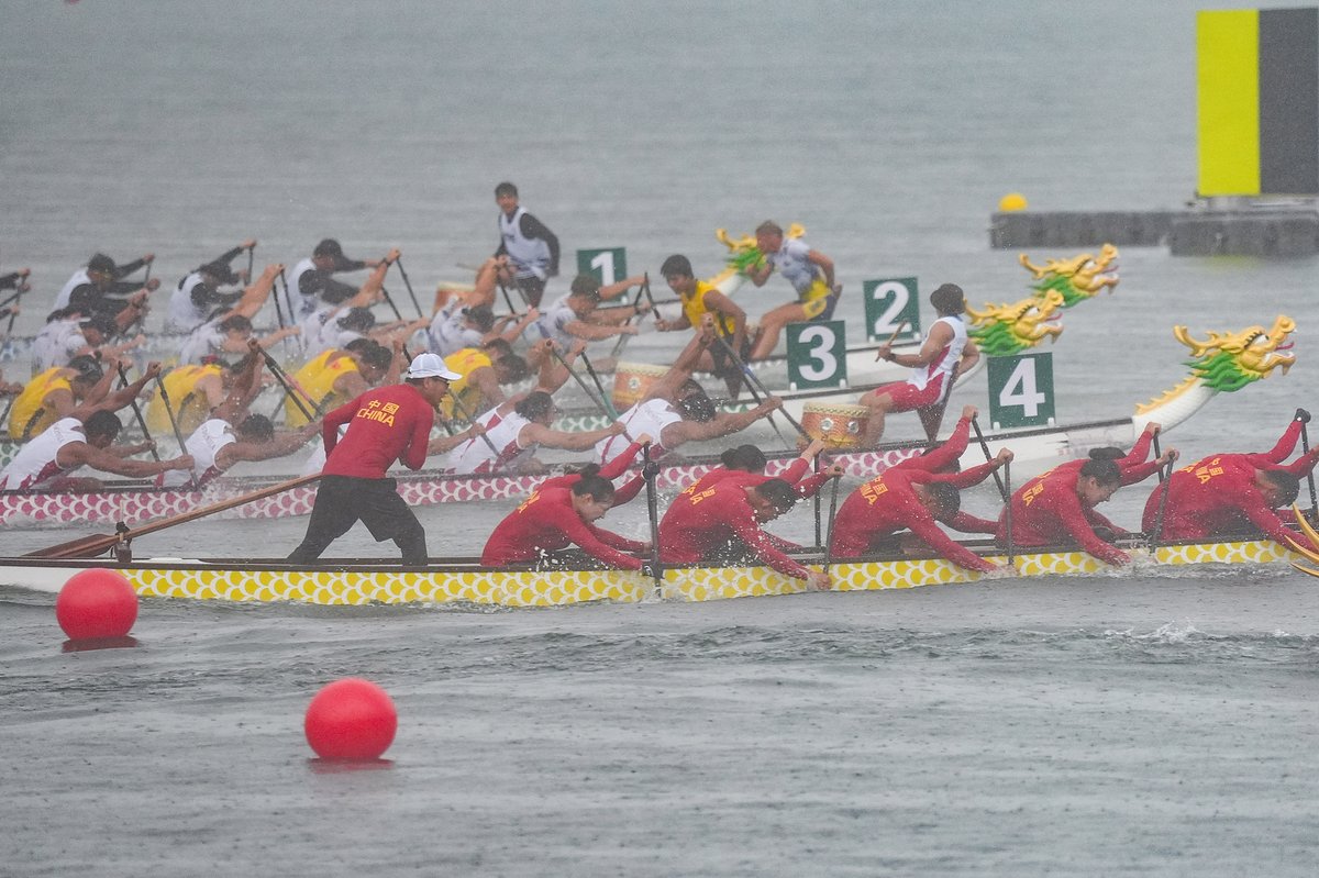 Competitors racing to the finish line in the 200m dragon boat race competition