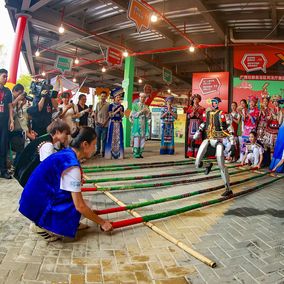 Chinese ethnic minorities celebrating Sanyuesan and robots