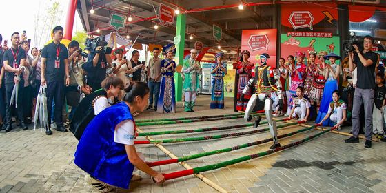 Chinese ethnic minorities celebrating Sanyuesan and robots