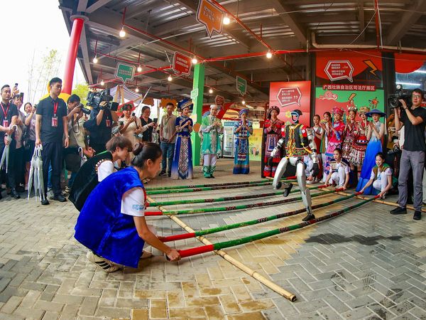 Chinese ethnic minorities celebrating Sanyuesan and robots