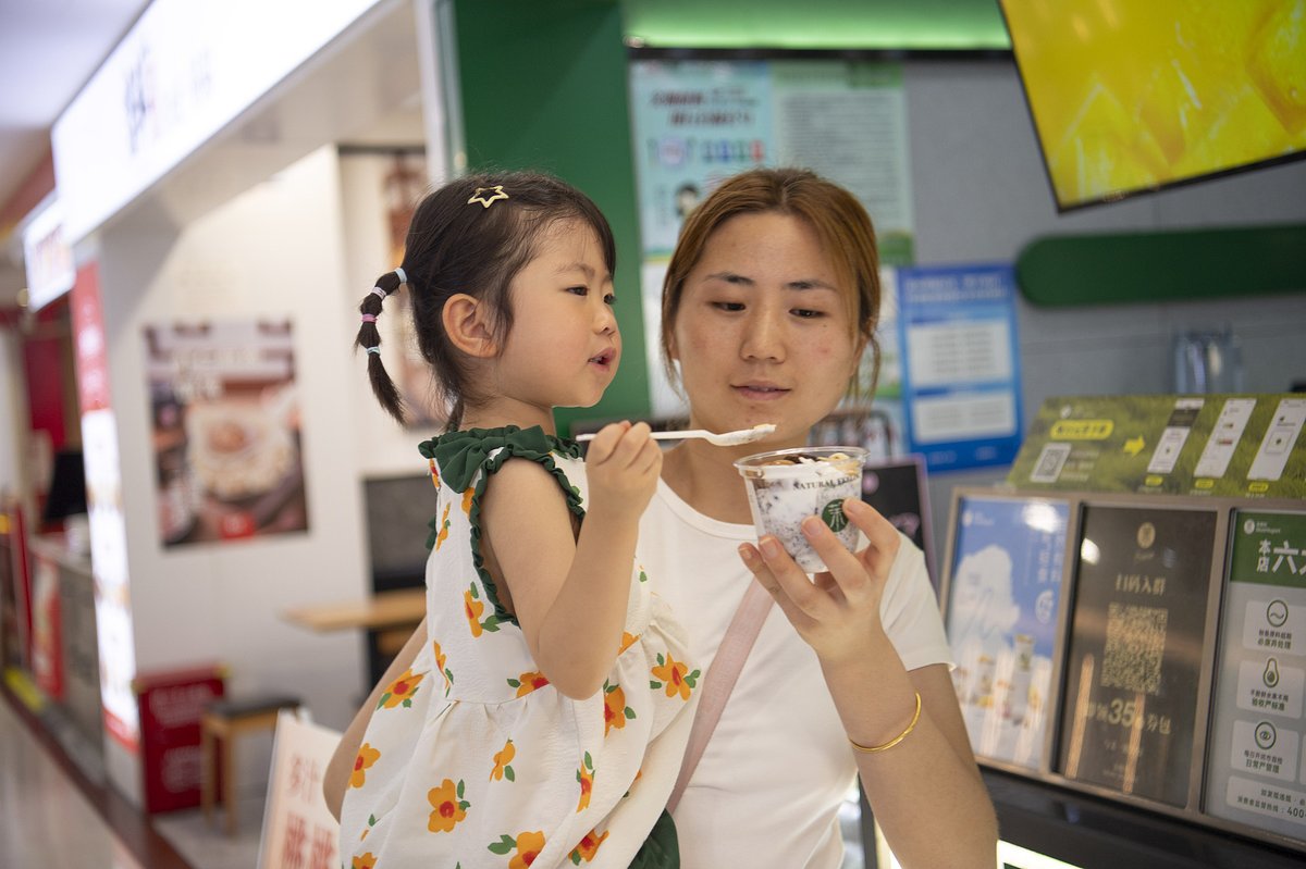 A Chinese mother and daughter enjoying  a bowl of yogurt in Zhejiang province