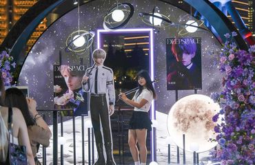 Chinese fangirls posing with Love and Deepspace characters